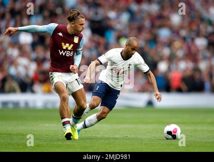 Aston Villa's Jack Grealish, left, duels for the ball with Tottenham's Lucas Moura during the English Premier League soccer match between Tottenham Hotspur and Aston Villa at the Tottenham Hotspur stadium in London, Saturday, Aug. 10, 2019. (AP Photo/Frank Augstein)