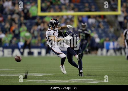 Seattle Seahawks defensive back Marquise Blair, right, hits Denver Broncos  wide receiver Nick Williams, drawing a penalty flag for unnecessary  roughness, during the second half of an NFL football preseason game,  Thursday