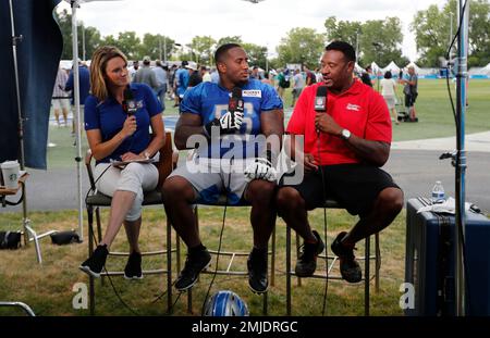 NFL Network analyst Willie McGinest, right, talks with New England Patriots  receiver Julian Edelman after drills at the Detroit Lions NFL football  training facility, Wednesday, Aug. 7, 2019, in Allen Park, Mich. (