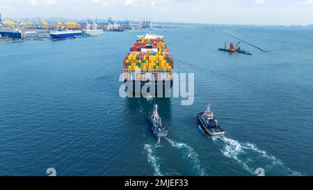 Tub Boat with Stern of cargo ship carrying container and running for import goods from cargo yard port to custom ocean concept technology transportati Stock Photo