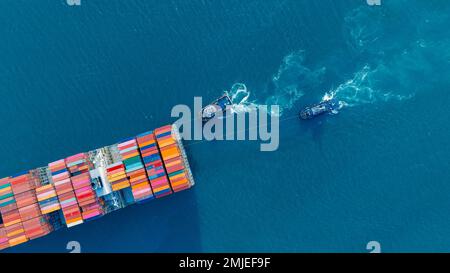 Tub Boat with Stern of cargo ship carrying container and running for import goods from cargo yard port to custom ocean concept technology transportati Stock Photo