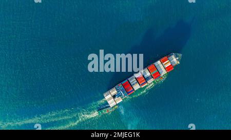 Tub Boat with Stern of cargo ship carrying container and running for import goods from cargo yard port to custom ocean concept technology transportati Stock Photo