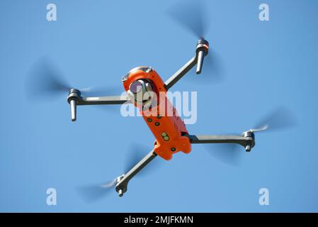 LENINGRAD REGION, RUSSIA - MAY 30, 2021: Autel Robotics EVO II quadcopter hovering overhead in a blue cloudless sky Stock Photo