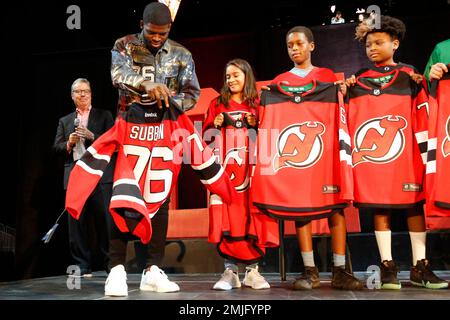 New Jersey Devils All-Star defenseman P.K. Subban, right, signs a jersey  for a young fan, Thursday, July 25, 2019, at the Prudential Center in  Newark, N.J. (AP Photo/Kathy Willens Stock Photo 