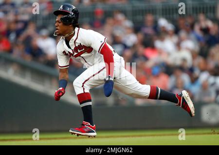 Atlanta Braves center fielder Ronald Acuna Jr. (13) can't keep a glove on a  ball off the bat of Detroit Tigers' Brandon Dixon who doubled during the  eighth inning of a baseball