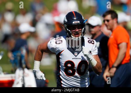 Denver Broncos tight ends coach Jake Moreland chats with tight end Eric  Saubert as he takes part in drills during the NFL football team's training  camp Thursday, Aug. 4, 2022, at the