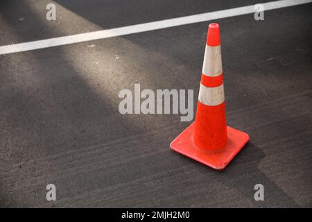 construction cones middle of street roadblock danger orange Stock Photo