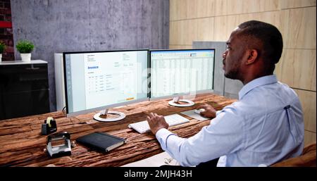 Medical Codes And Accounts Manager In Office With Bill Stock Photo