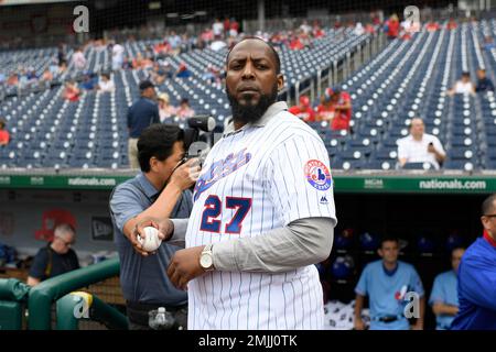 Baseball Hall of Famer Vladimir Guerrero, left, stands on the field next to Washington  Nationals manager Dave Martinez (4) before a baseball game against the  Kansas City Royals, Saturday, July 6, 2019