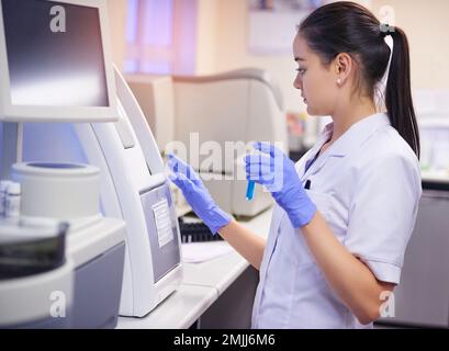 Quicker results with cutting edge lab technology. a young scientist conducting a medical test in a laboratory. Stock Photo