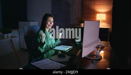 Successful Stock Market Trader Looking At Graphs On Multiple Screens In Office Stock Photo