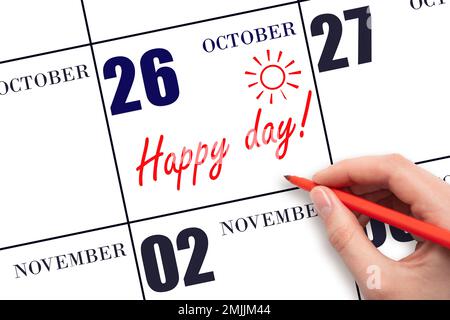 26th day of October. Hand writing the text HAPPY DAY and drawing the sun on the calendar date October 26. Save the date. Holiday. Motivation. Autumn m Stock Photo