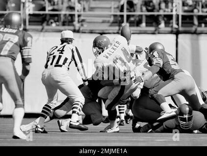 New Jersey Generals' Herschel Walker is held to a six-yard gain by Fred  Nordgren of the Tampa Bay Bandits during the Generals' home opening game at  Giants Stadium in East Rutherford, N.J.