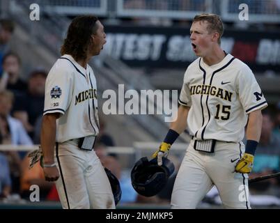 Michigan's Jimmy Kerr, right, celebrates after hitting a 2-run home run
