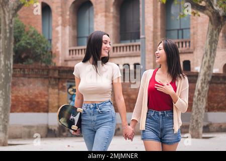women walking having fun through the city Stock Photo