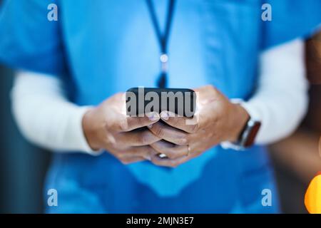 Phone, hands and medical nurse in hospital working on telehealth, research or online consultation. Healthcare smartphone, woman and female physician Stock Photo