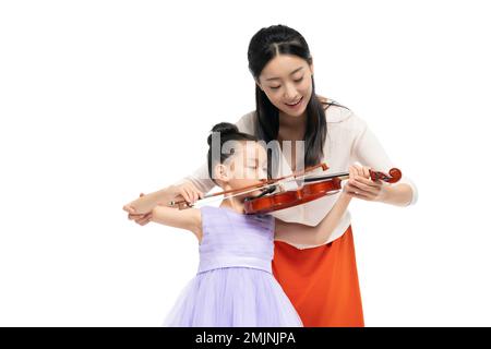 The female teacher guide girl playing Musical Instruments Stock Photo