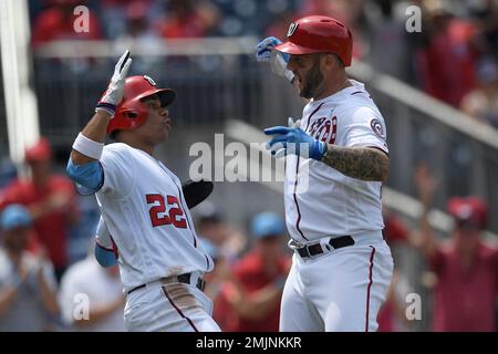 Washington Nationals' Matt Adams, right, celebrates his three-run home run  as Arizona Diamondbacks catcher Caleb Joseph, center, and umpire home plate  Sean Barber (29) look on during the third inning of a