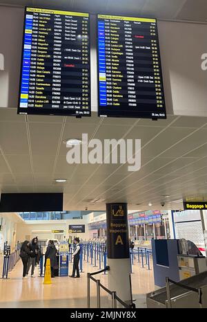 The departure boards at Manchester Airport showing two cancelled Flybe flights as the regional carrier has ceased trading and all scheduled flights have been cancelled, authorities have said. Picture date: Saturday January 28, 2023. Stock Photo