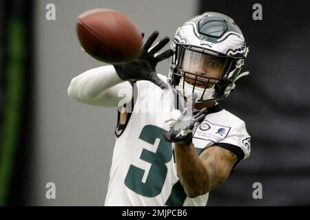 Dallas Cowboys running back Ezekiel Elliott (21) hurdles Philadelphia  Eagles defensive back Tre Sullivan (37) during