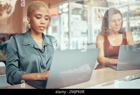 Laptop, working and business black woman in cafe window for networking, planning and writing email. Communication, internet and female workers typing Stock Photo