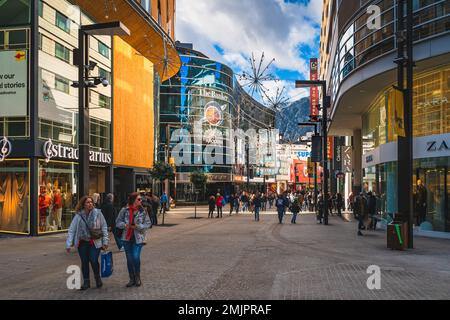 Andorra la Vella, Andorra, Jan 2020 People duty free shopping, street with modern shops and restaurants. Capital city in Pyrenees Mountains Stock Photo