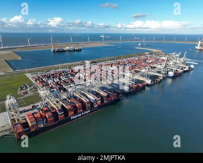 Rotterdam, 19th of January 2023, The Netherlands. Container ship unloading removing cargo containers from a vessel. Cranes to lift the containers off Stock Photo