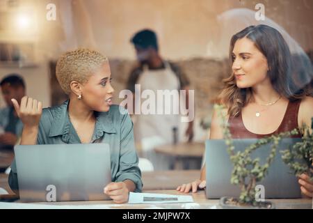 Discussion, laptop and business women in cafe window for conversation, planning and b2b networking. Communication, teamwork and female workers talking Stock Photo