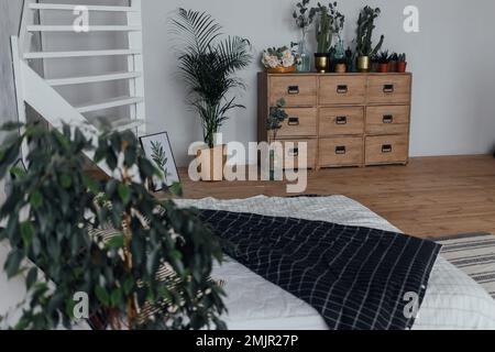 Stylish chest of drawers in a bright and white apartment under natural lighting. Stock Photo