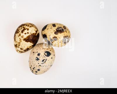 top view of few boiled quail eggs on light brown wooden table with copyspace Stock Photo