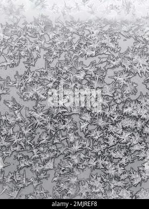 ice crystals on surface on home window glass on cold winter day Stock Photo