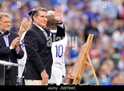 Former Los Angeles Dodger Steve Garvey presents Irvin Magic Johnson with  his Dodger jersey as the new owners of the Los Angeles Dodgers, known as  the Guggenheim Baseball Management Team, hold a