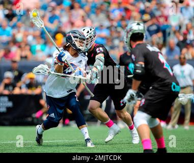 IMAGE DISTRIBUTED FOR PREMIER LACROSSE LEAGUE - Archers midfielder Austin  Sims (18) is defended by Atlas defender Kyle Hartzell (81)during a Premier  Lacrosse League game on Friday, June 28, 2019 in Atlanta. (