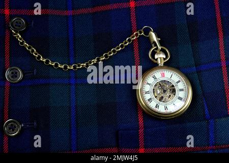 Scottish tartan waistcoat with old pocket watch and chain closeup Stock Photo