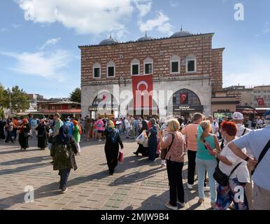 Istanbul, Turkey - August 30, 2022: Crowds of local citizens at Eminonu during the Victory Day holiday with entrance of The Spice Bazaar, aka Misir Carsisi, or Egyptian Bazaar in the background Stock Photo