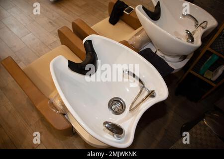 Hair washing sinks in beauty salon Stock Photo - Alamy