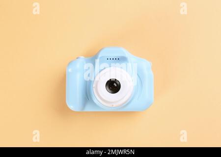 Light blue toy camera on beige background, top view Stock Photo