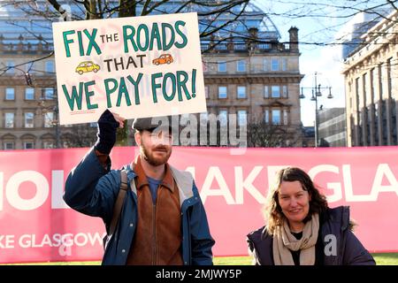 Glasgow, Scotland, UK. 28th January 2023.  Sort Glasgows Roads Protest outside the City Chambers in George Square. A protest publicising the bad state of Glasgows roads and the numerous dangerous potholes.  Credit: Craig Brown/Alamy Live News Stock Photo