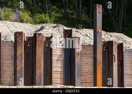 Strengthening the slope of the ravine, rusty steel beams. Industrial background photo Stock Photo