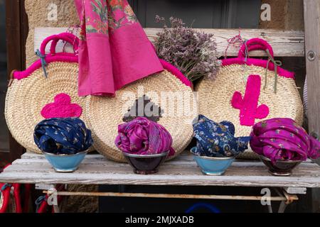 Shopping street scarves and baskets display closeup in outdoor market shop store Stock Photo