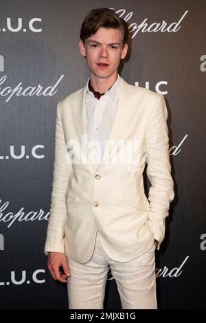 Thomas Brodie Sangster poses for photographers upon arrival at