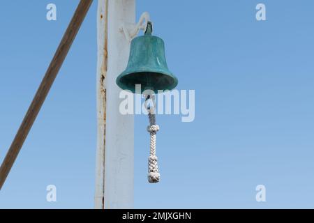 copper bell on boat yacht on blue sky background Stock Photo