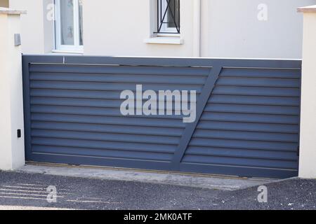 gray steel sliding portal home suburb metal aluminum house modern grey gate Stock Photo