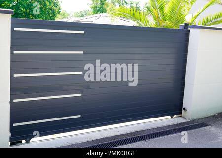 Aluminum slide door grey sliding metal gate house portal of suburb home Stock Photo