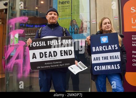 London, UK. 28th January 2023. Extinction Rebellion Doctors, a group of actual doctors and medical professionals, staged a demonstration outside Barclays on Tottenham Court Road in protest against the bank’s continued financing of fossil fuels. Earlier in the day, a different group of activists spray-painted ‘Climate Criminals’ and stuck ‘In case of climate emergency break glass’ stickers on the window in response to yesterday’s verdict about the activist women who smashed Barclays HQ windows. Credit: Vuk Valcic/Alamy Live News. Stock Photo