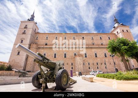 Cannon in the foreground with the walls and towers of the Alcazar of Toledo behind it Stock Photo