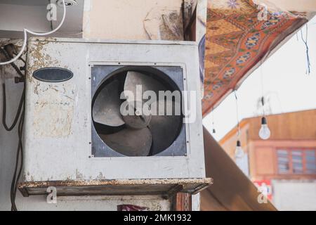 broken dirty air conditioner on the home in Africa Stock Photo