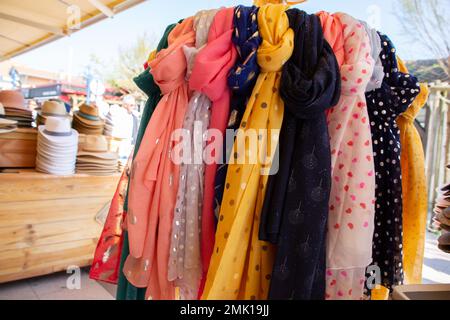 Silk scarves hand hat for sale at a street market Stock Photo