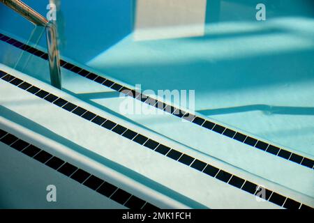 Swimming pool, handrail and stairs Stock Photo