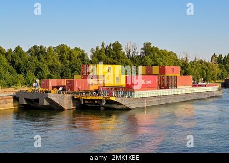 Antwerp, Belgium - August 2022: Shipping containers loaded onto industrial barges. Stock Photo